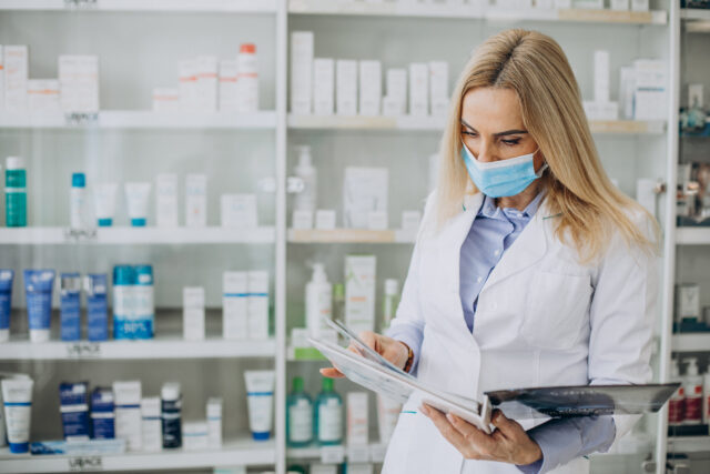 Woman working at pharmacy and wearing coat